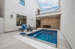 View of pool with a jacuzzi and a patio area