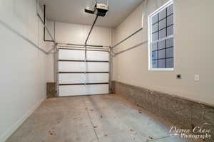 Garage featuring a garage door opener