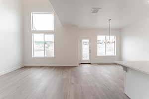 Interior space with a notable chandelier and light hardwood / wood-style floors