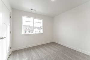 Carpeted empty room featuring a textured ceiling