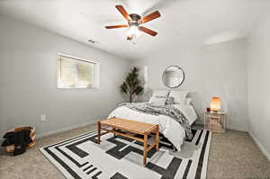 Carpeted bedroom featuring ceiling fan