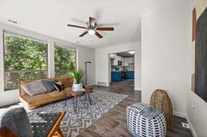 Living room featuring dark hardwood / wood-style floors and ceiling fan