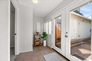 Entryway with light tile patterned floors