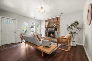 Living room featuring wood-type flooring and a fireplace