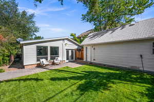 Back of house featuring a yard and a patio area