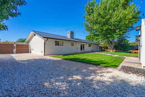 Rear view of house with a yard, central AC, and a patio area