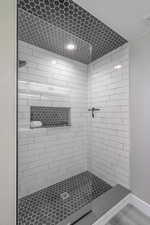 Bathroom with lofted ceiling and a tile shower