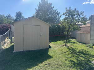 View of outdoor structure featuring a yard