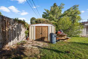 View of outbuilding featuring a lawn