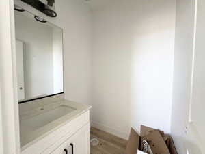 Bathroom with vanity and hardwood / wood-style floors