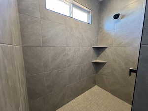 Bathroom featuring a tile shower