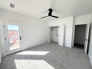 Unfurnished bedroom featuring access to exterior, light colored carpet, and ceiling fan