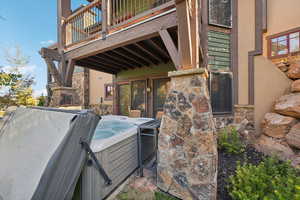 Exterior space featuring a balcony and a hot tub