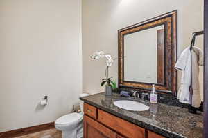 Bathroom featuring vanity, toilet, and tile patterned floors