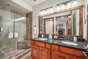 Bathroom featuring vanity and an enclosed shower