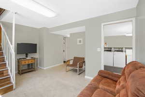 Living room featuring washing machine and clothes dryer