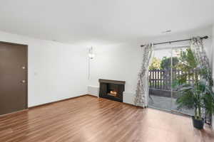 Unfurnished living room with wood-type flooring