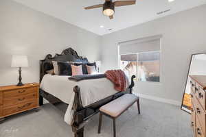 Carpeted bedroom with ceiling fan