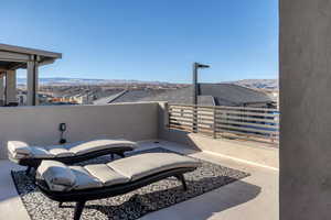 View of patio featuring a balcony and a mountain view