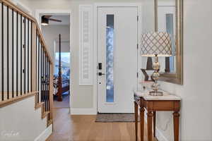 Foyer entrance with light wood-type flooring and plenty of natural light