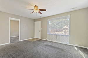 Interior space featuring a textured ceiling and ceiling fan