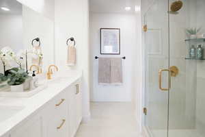 Bathroom with vanity and a shower with shower door