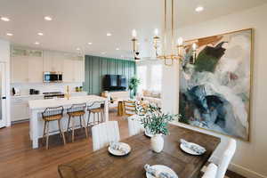 Dining area with ceiling fan and dark wood-type flooring