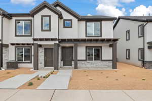 Multi unit property with central AC unit, a pergola, and a patio area