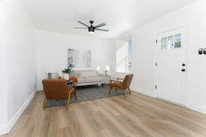 Living room featuring light wood-type flooring and ceiling fan