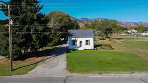 View of front of home featuring a front yard and a mountain view