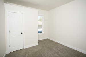 Empty room featuring carpet flooring