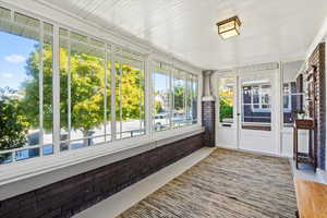 Unfurnished sunroom with a wealth of natural light