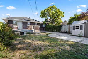 View of yard featuring a storage unit and a patio area