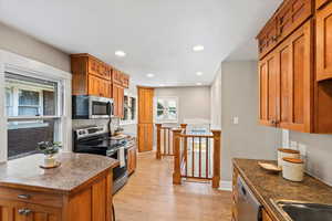 Kitchen featuring appliances with stainless steel finishes, a center island,