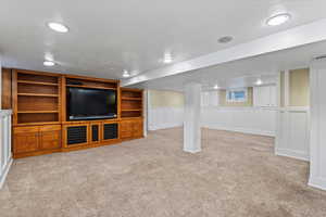 Interior space featuring light colored carpet and ornate columns