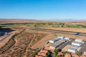 Birds eye view of property with a mountain view and a rural view