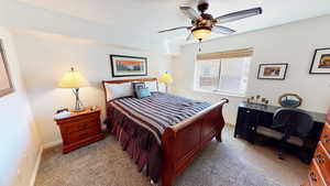 Bedroom with ceiling fan and light colored carpet