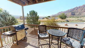 Wooden deck with area for grilling and a mountain view