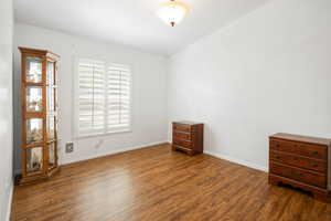 Spare room with dark wood-type flooring