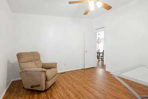 Sitting room featuring wood-type flooring and ceiling fan