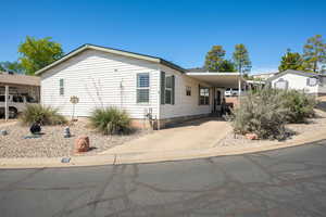 Manufactured / mobile home featuring a carport