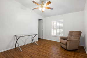 Living area featuring dark hardwood / wood-style flooring and ceiling fan