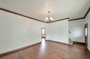 Formal living room with entryway and stairs to upstairs.