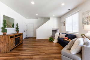 Living room with dark wood-type flooring