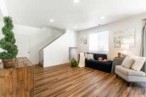 Living area with a textured ceiling and dark hardwood / wood-style floors