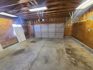 Generous over-sized garage featuring a garage door opener