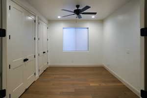 Spacious office with French doors, ceiling fan, and a full wall of storage space. This space could also be bedroom 4.