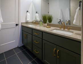 Owner's bath with huge walk-in shower, dual vanities, elegant lighting and brush 'gold' Delta Trinsic fixtures.