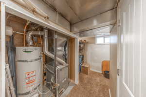 Utility room with heating unit and strapped water heater