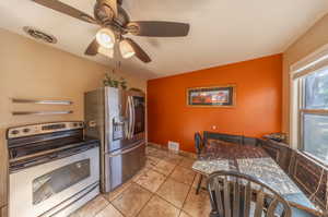 Kitchen featuring ceiling fan and appliances with stainless steel finishes